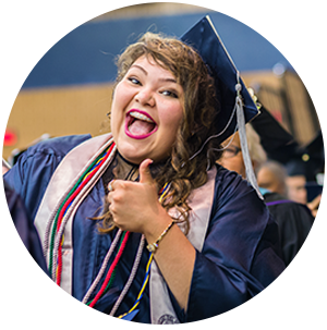 Student with graduation cap giving thumbs up and smiling